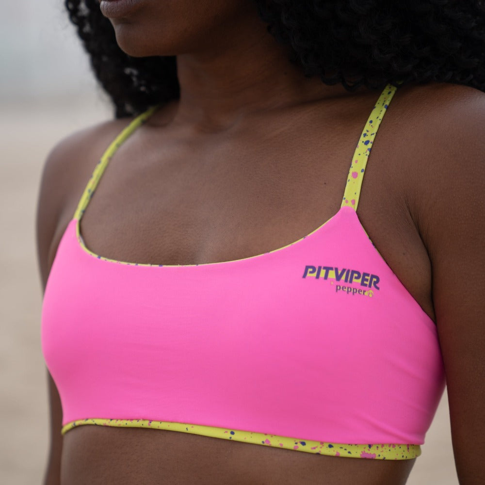 Close up of pink side of reversible Pitviper and Pepper 1993 collaboration top. Reverses to lime splatter.