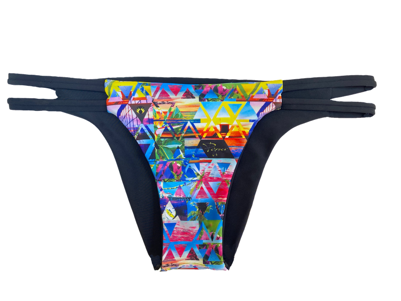 An attractive and stylish reversible sport bikini bottom featuring a colorful custom beach volleyball lifestyle print and two black straps on both hips; reverses to a solid black fabric.