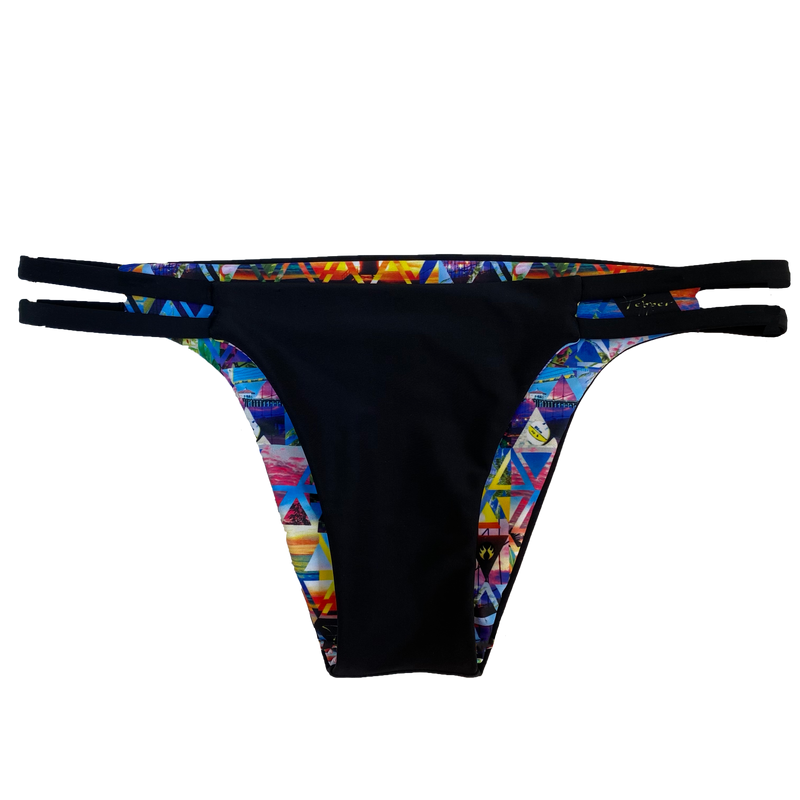 An attractive and stylish reversible sport bikini bottom in solid black fabric two black straps on both hips; reverses to a colorful custom beach volleyball lifestyle print.