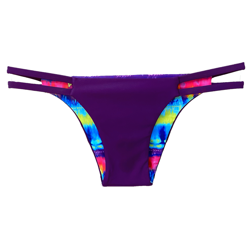  An attractive and stylish reversible sport bikini bottom featuring a solid plum colored fabric with two plum straps on the hips; reverses to a colorful tie dye print.