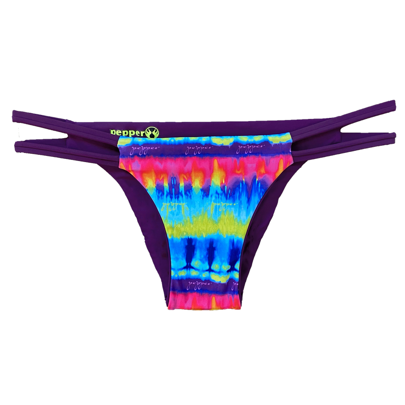 An attractive and stylish reversible sport bikini bottom featuring a colorful tie dye print fabric with two plum straps on the hips; reverses to a solid plum colored fabric.