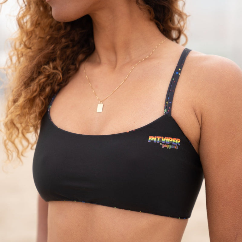 VolleybClose up of Pitviper Pepper Collaboration Top in Black and custom Rollerdome Print Sportsbra Top Reversible. 